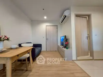 Modern living room with cozy seating and stylish decor in a contemporary apartment.