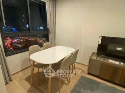 Modern dining area with city view, featuring sleek table and chairs, perfect for urban living.