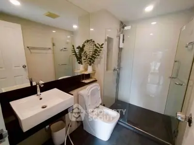 Modern bathroom with sleek fixtures and glass shower enclosure