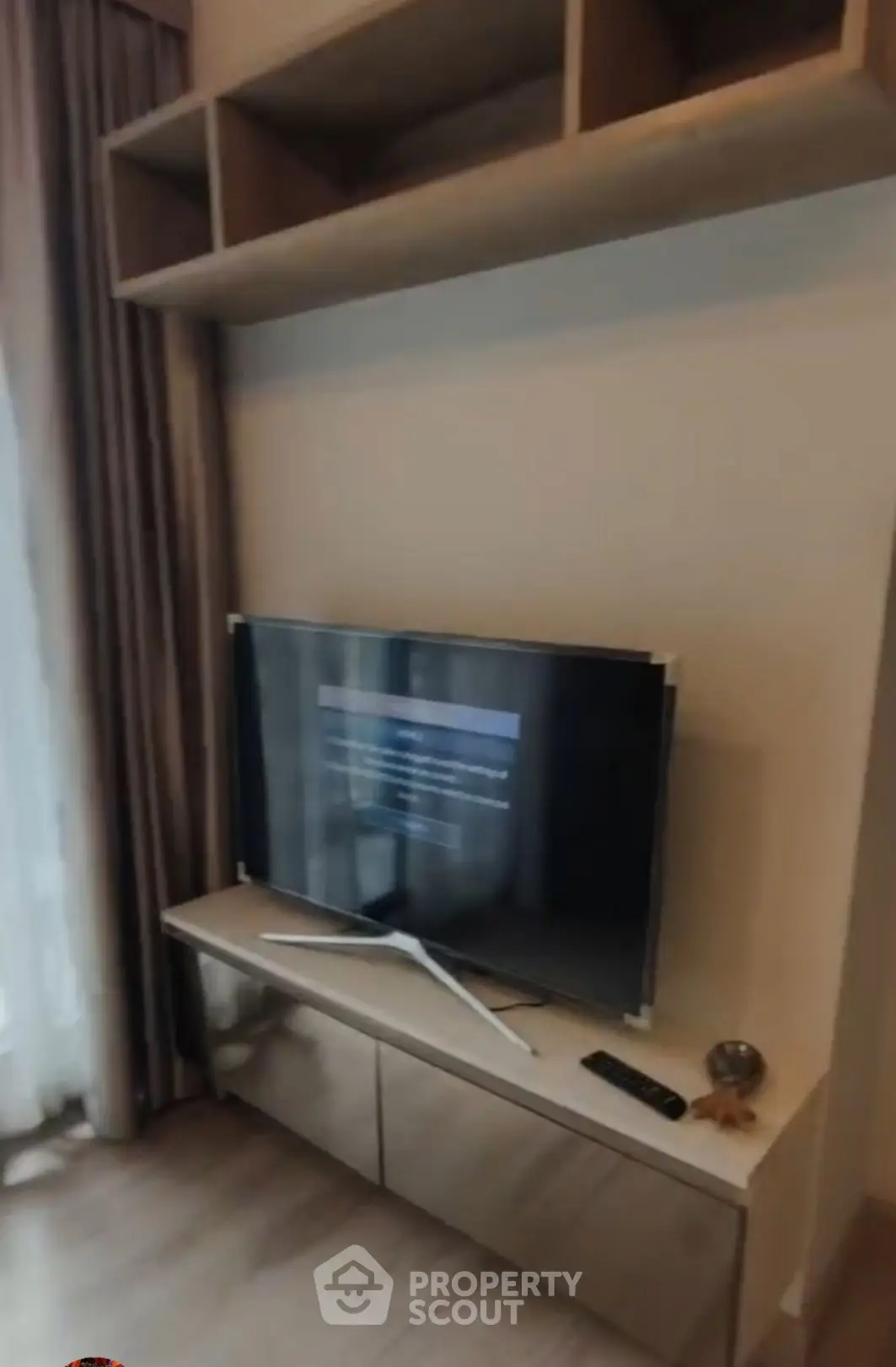 Modern living room with sleek TV setup and stylish shelving