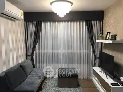 Modern living room with elegant curtains, plush sofa, and sleek TV setup.