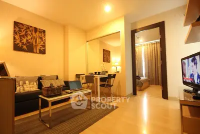 Cozy living room with modern decor and view into a stylish bedroom