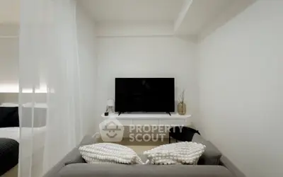 Modern living room with sleek TV setup and cozy sofa