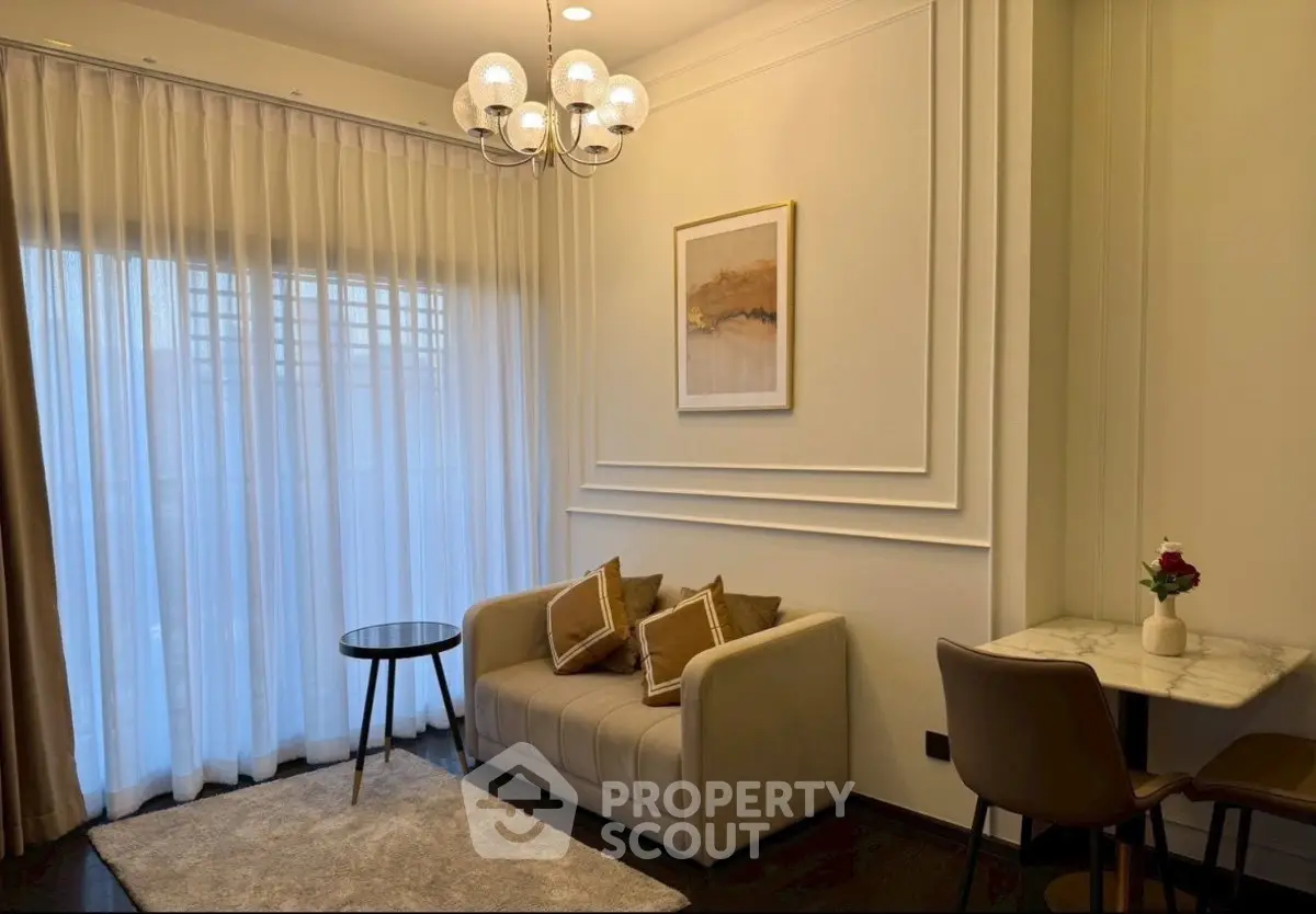 Chic living room with elegant decor, cozy sofa, and stylish lighting in modern apartment.