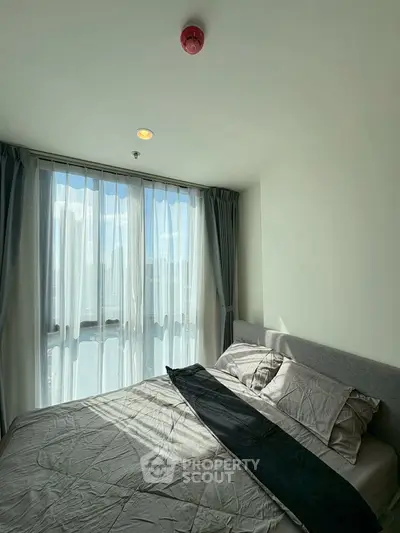 Bright bedroom with large window and modern decor