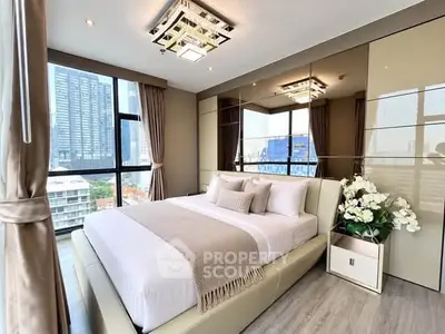 Luxurious bedroom with floor-to-ceiling windows offering stunning city views, elegant decor, and modern lighting.