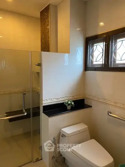 Modern bathroom with glass shower and elegant fixtures