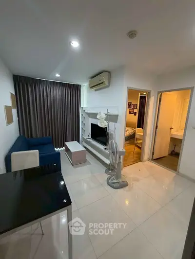 Modern living room with sleek furniture and air conditioning in a cozy apartment.