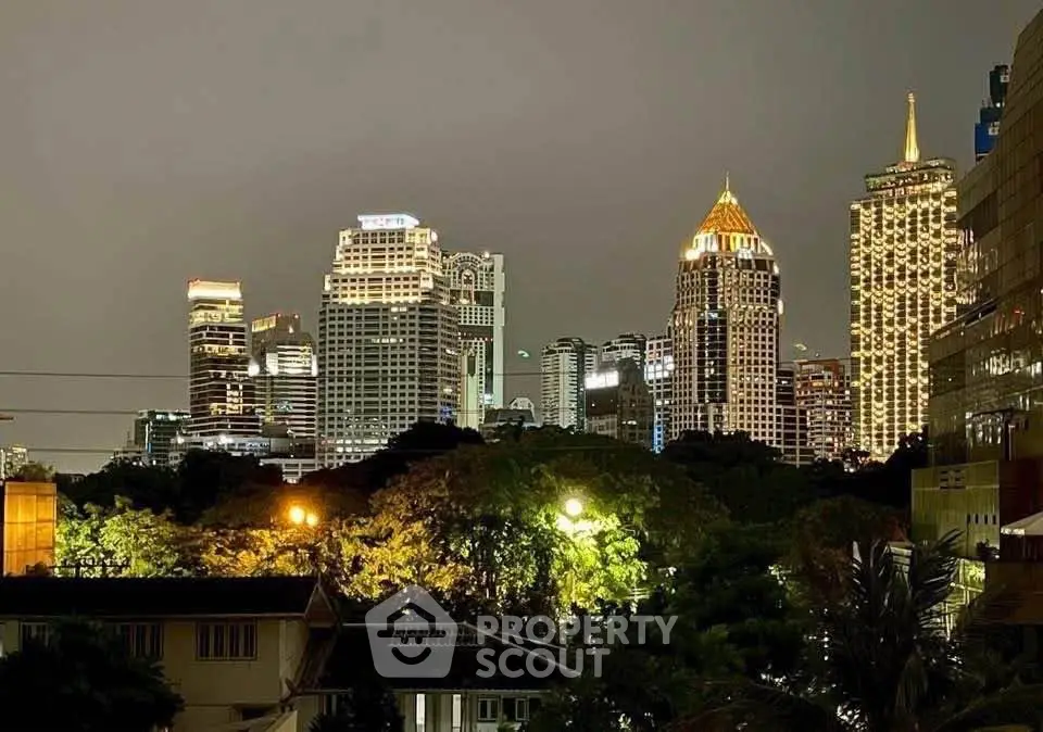Stunning city skyline view with illuminated skyscrapers at night, perfect for urban living enthusiasts.