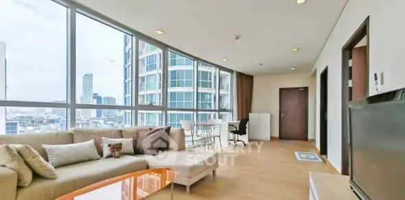 Spacious modern living room with panoramic city views and elegant furnishings.