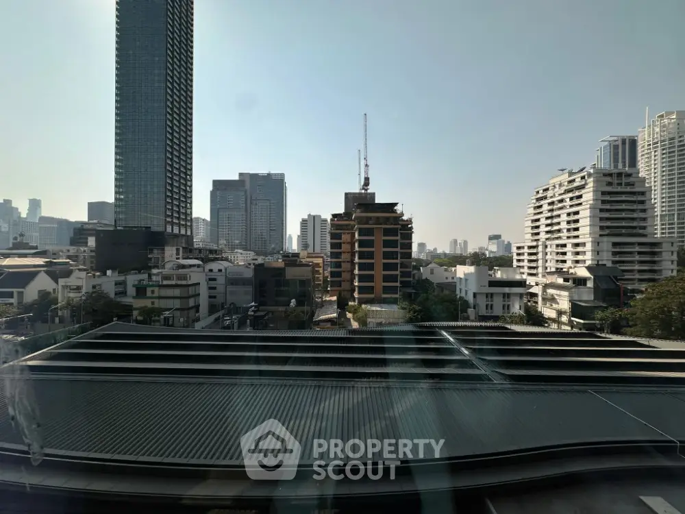 Stunning cityscape view from high-rise building showcasing urban skyline and modern architecture.
