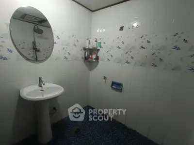 Spacious bathroom with modern fixtures and decorative tiles