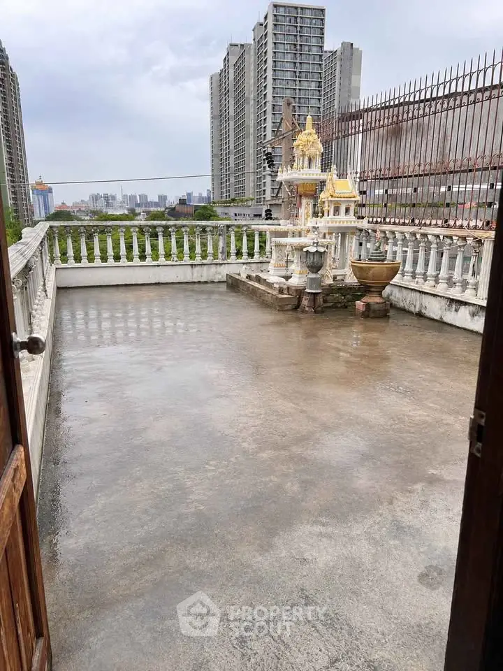 Spacious rooftop terrace with city views and traditional shrine, perfect for relaxation and gatherings.