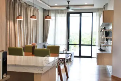Modern open-plan living room with stylish decor and large windows for natural light.