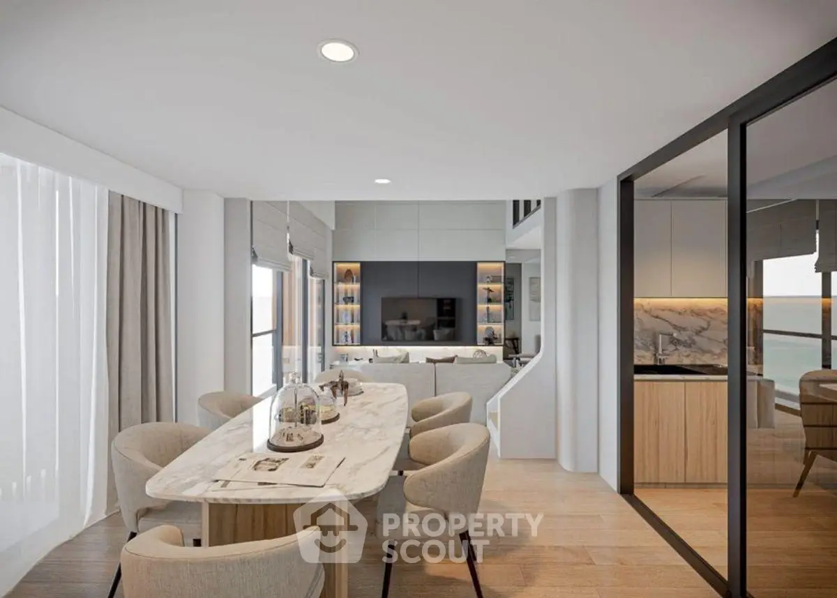 Luxurious open-plan living and dining area with modern furnishings and ocean view.