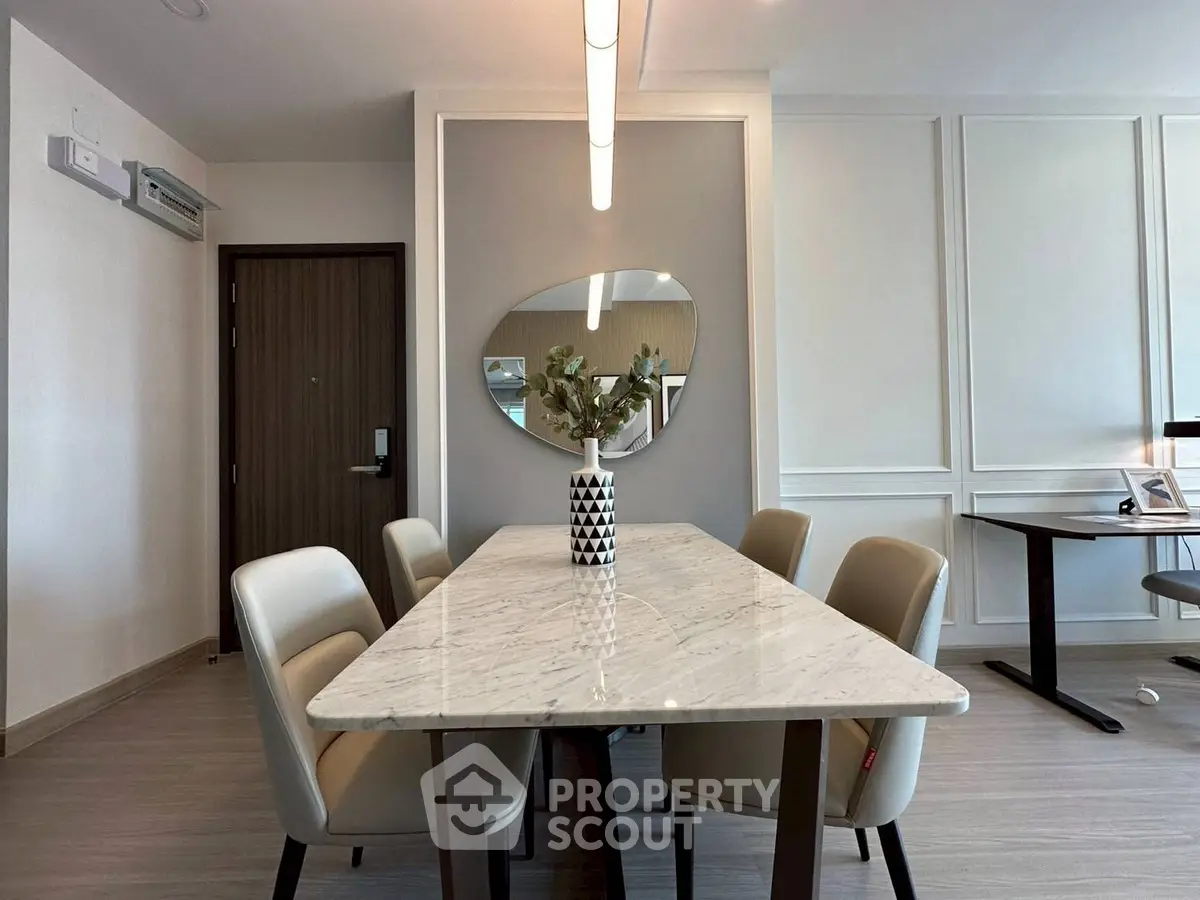 Elegant dining area with marble table and modern decor in a stylish apartment.