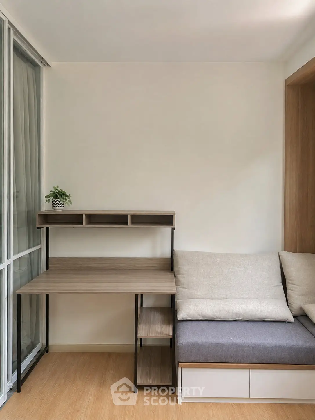 Modern study nook with sleek desk and cozy seating in a stylish apartment.
