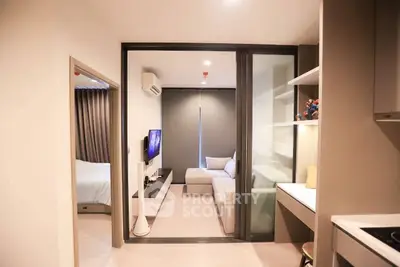 Modern apartment interior with cozy living room and bedroom, featuring sleek design and neutral tones.