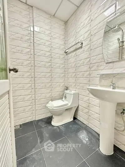 Modern bathroom with sleek fixtures and tiled walls