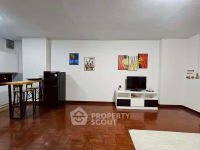 Spacious living room with modern decor and wooden flooring