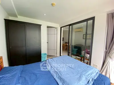 Spacious bedroom with modern decor and large wardrobe in a stylish apartment.
