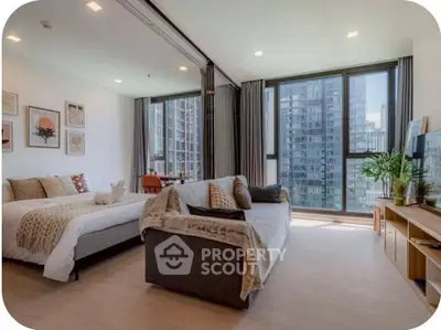 Spacious modern living room with large windows and stylish decor in urban apartment