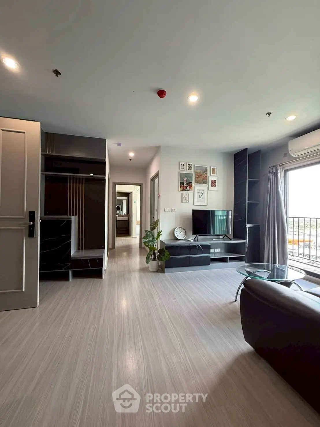 Modern living room with sleek furniture and large windows offering natural light and a cozy atmosphere.