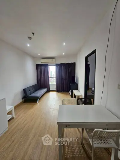 Spacious living room with modern furniture and wooden flooring