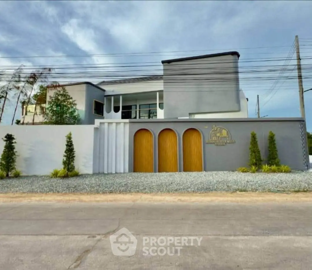 Modern architectural home exterior with sleek design and elegant entrance.