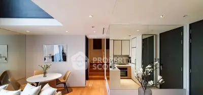 Modern open-plan living room with dining area and sleek kitchen design