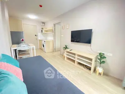 Modern living room with wall-mounted TV and compact kitchen area