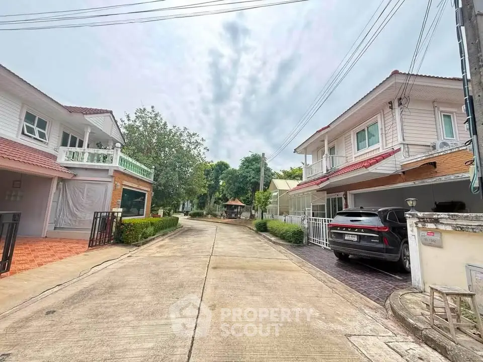 Charming suburban street with modern houses and lush greenery, perfect for family living.