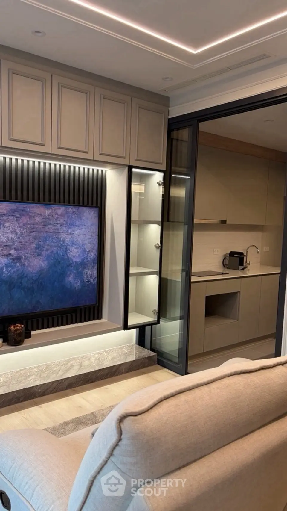 Modern living room with sleek kitchen view and elegant decor