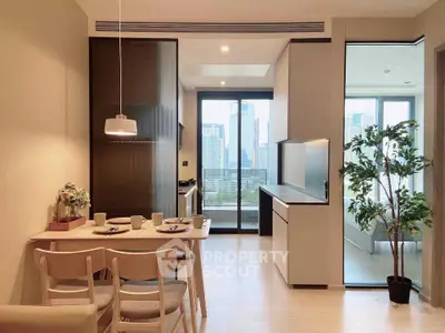 Modern open-plan kitchen and dining area with city view, featuring sleek design and natural light.