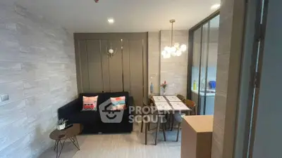 Modern living room with stylish decor and dining area in open layout apartment.