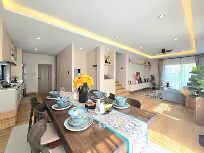 Spacious open-plan living and dining area with modern decor and natural light.