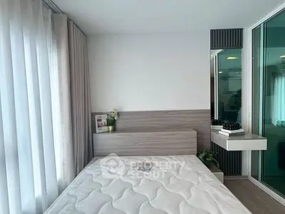 Modern bedroom with stylish decor and large window for natural light