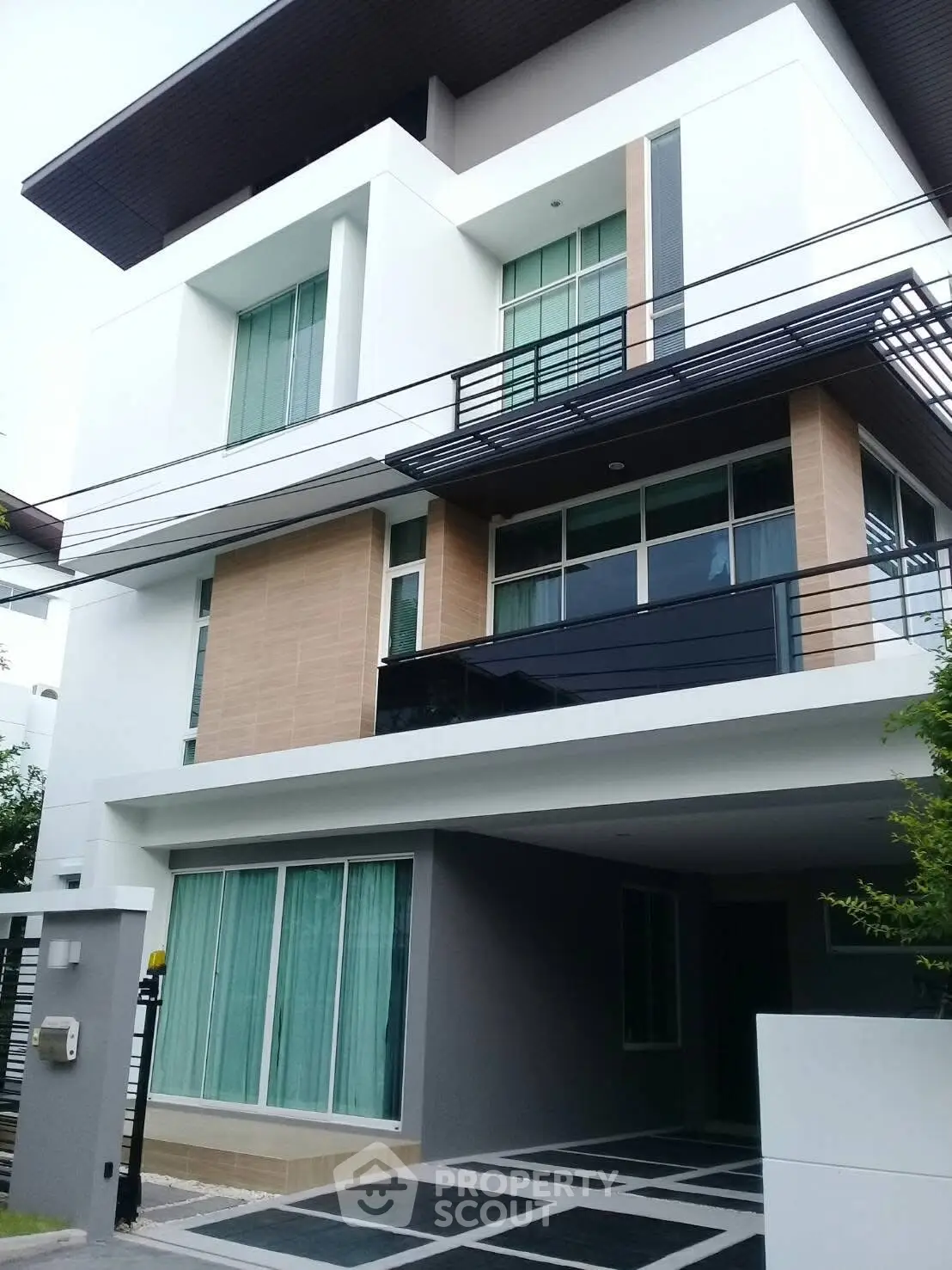 Modern three-story house with sleek design and spacious balcony