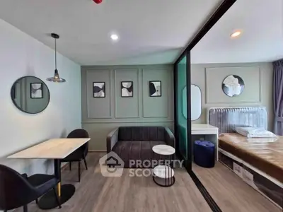 Modern studio apartment with stylish decor and open layout, featuring a cozy living area and bedroom.