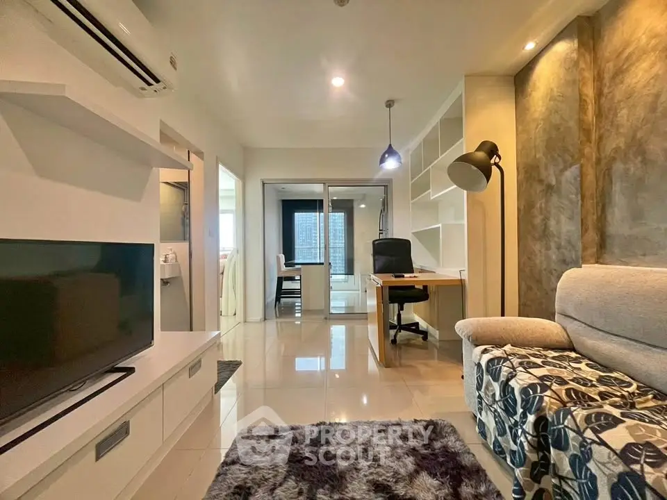 Modern living room with stylish decor and open study area, featuring sleek furniture and ambient lighting.