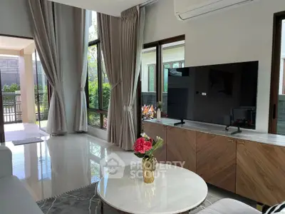 Spacious living room with modern decor and large windows offering garden views.