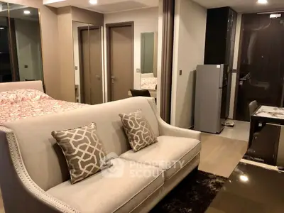 Modern studio apartment with stylish decor and open layout, featuring a cozy living area and sleek kitchen.