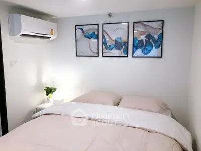 Cozy bedroom with modern decor and air conditioning, perfect for relaxation.