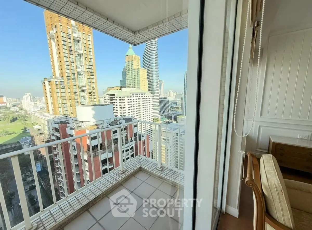 Stunning city view from a high-rise balcony with modern urban skyline.