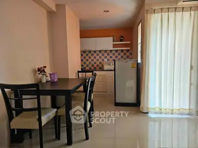 Charming kitchen with dining area, featuring modern appliances and natural light, perfect for cozy meals.
