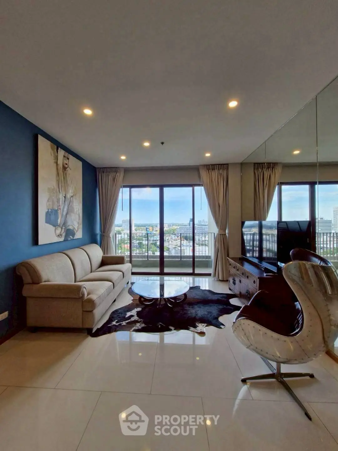 Spacious living room with stunning city view and modern furnishings
