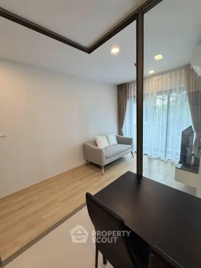 Modern living room with glass partition and cozy sofa in a stylish apartment