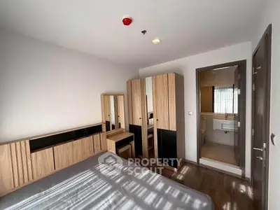 Modern bedroom with ensuite bathroom and stylish wooden furniture