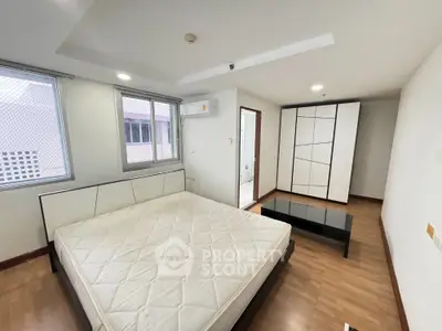 Spacious bedroom with modern design and ample natural light