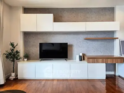 Modern living room with sleek white cabinets and hardwood floors
